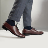 Styled Fit Perspective of Director Wholecut Maroon Leather Shoes For Men on Model - Natural Daylight Drape
